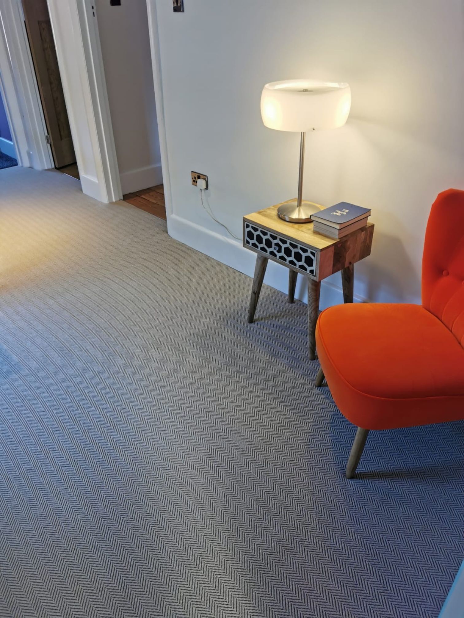 Alternative flooring Carpet in a lovely hallway with a orange chair front